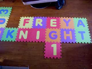 Interlocking tiles spell out Freya's name and age